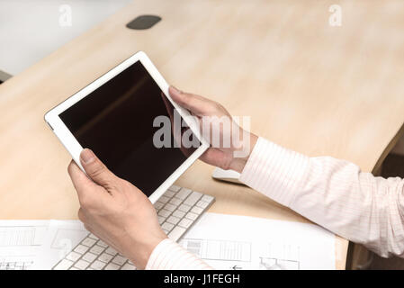 close up hands young engineer using tablet, laptop and cellphone connecting wifi Stock Photo