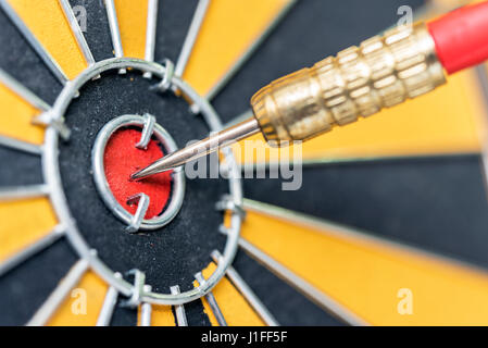 closeup dart arrow hitting in target bullseye of dartboard, business data integration solutions and success concept Stock Photo