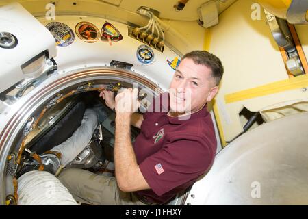 NASA Expedition 50 prime crew member American astronaut Shane Kimbrough signs a bulkhead on the Russian segment of the International Space Station next to the Soyuz MS-03 spacecraft crew patch March 5, 2017 in Earth orbit.       (photo by NASA Photo /NASA   via Planetpix) Stock Photo