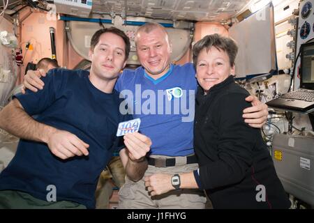 NASA Expedition 50 prime crew members (L-R) French astronaut Thomas Pesquet of the European Space Agency, Russian cosmonaut Oleg Novitskiy of Roscosmos, and American astronaut Peggy Whitson celebrate 100 days in space aboard the International Space Station with a traditional flight patch February 25, 2017 in Earth orbit.      (photo by NASA Photo /NASA   via Planetpix) Stock Photo