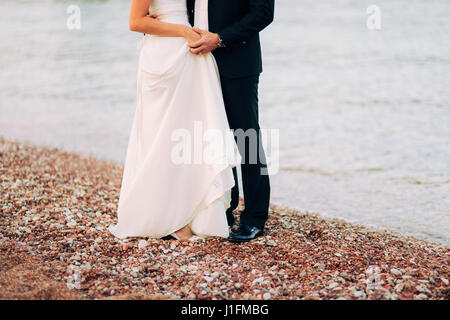 Women's and men's feet in the sand Stock Photo