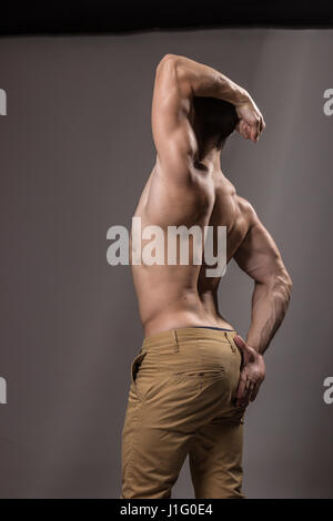 Muscular man posing with arm raised, showcasing fitness and strength ...