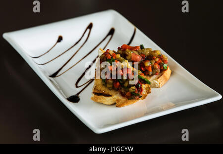 Selection of tasty bruschetta or canapes on taosted baguette with eggplant Stock Photo
