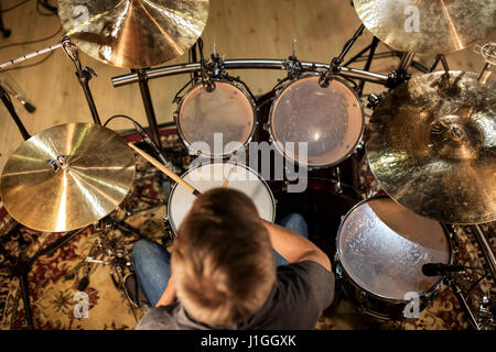 male musician playing drums and cymbals at concert Stock Photo
