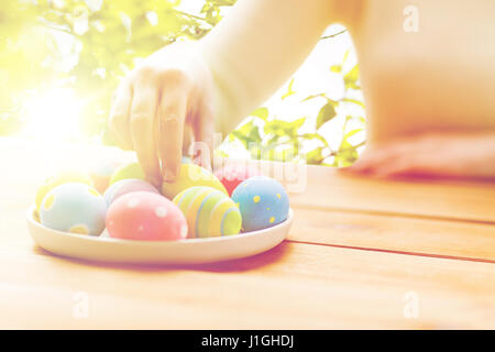 close up of woman hands with colored easter eggs Stock Photo