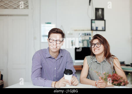 Two creative designers working at white office Stock Photo
