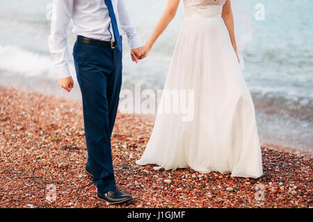 Women's and men's feet in the sand Stock Photo