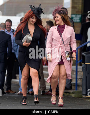 Racegoers arrive for Ladies Day of the Coral Scottish Grand National at Ayr Racecourse. Stock Photo