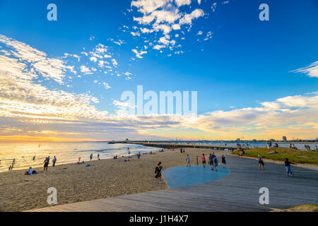 Melbourne, Australia - December 28, 2016: People spending time on St. Kilda Beach at sunset on a hot summer day, Victoria, Australia Stock Photo