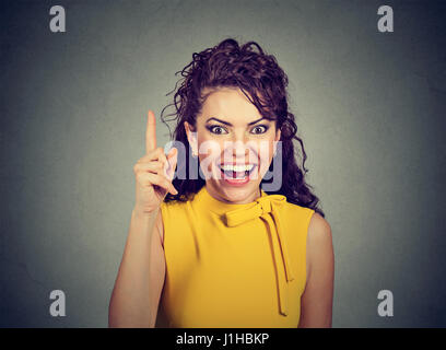 Attractive woman pointing finger up has an idea Stock Photo