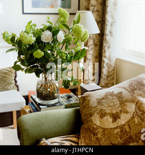 Flowers by sofa. Stock Photo