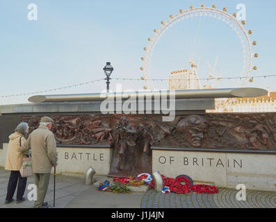 Elderly couple in front of the Bronze Battle of Britain monument by Paul day, Victoria Embankment, London, England Stock Photo