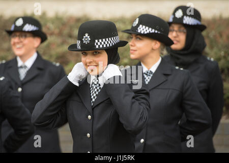 New Metropolitan Police officers check their uniforms before taking part in their passing-out parade at the Police Academy in Hendon, London. Stock Photo