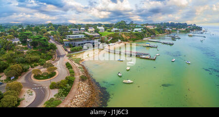 Aerial panoramic landscape of Sorrento suburb coastline with private piers and moored boats. Mornington Peninsula, Melbourne, Australia Stock Photo