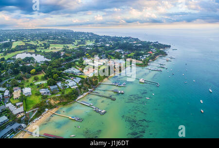 Aerial landscape of Sorrento suburb coastline with private piers and moored boats at sunrise. Mornington Peninsula, Melbourne, Australia Stock Photo