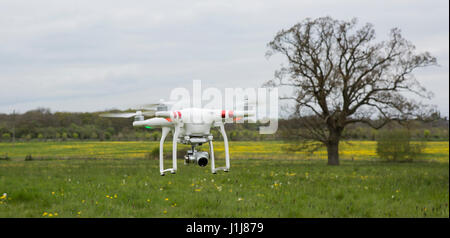 DJI Phantom drone makes low pass over farmland Stock Photo