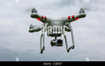 DJI Phantom drone against a dark cloudy sky Stock Photo