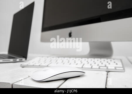 BELGRADE, SERBIA - MARCH 8, 2017: iMac computer and MacBook laptop on the table. iMac is a range of all-in-one Macintosh desktop computers designed an Stock Photo