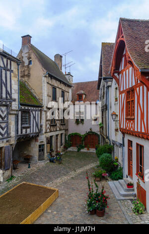 Sunrise view of a square (place de la petite etape aux vins), with half-timbered houses, in the medieval village Noyers-sur-Serein, Burgundy, France Stock Photo