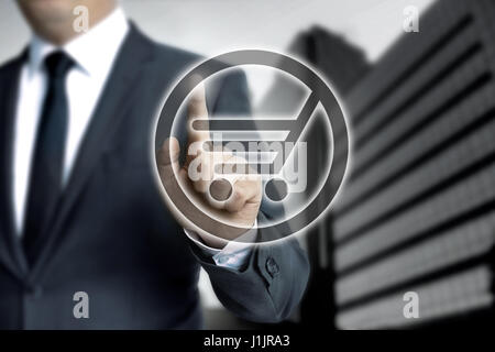 Shopping cart touchscreen is operated by businessman. Stock Photo
