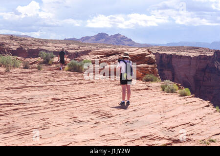 Couple exploring the desert around the red rock canyon of horseshoe bend. Stock Photo