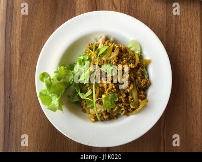 Flat lay photo of curry pork noodle in Thai style on wood table Stock Photo