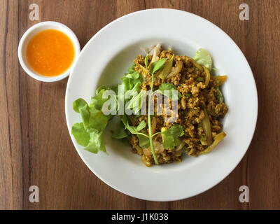 top view of curry pork noodle in Thai style on wood table Stock Photo