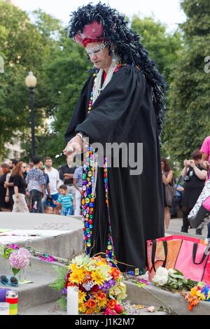 Washington, District Of Columbia, USA. 26th Jan, 2017. A mourner decorates the fountain during a candlelight vigil held in Dupont Circle in Washington, DC on June 13th, 2016, The vigil was held for the victims of the Pulse Nightclub shooting in Orlando, FL. Credit: Alex Edelman/ZUMA Wire/Alamy Live News Stock Photo