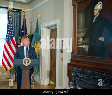 Washington DC, USA. 21st April, 2017. United States President Donald J. Trump makes remarks next to a portrait of Alexander Hamilton, the first US Secretary of the Treasury, prior to signing Executive Orders concerning financial services at the Department of the Treasury in Washington, DC on April 21, 2017. Credit: Ron Sachs/Pool via CNP /MediaPunch/Alamy Live News Stock Photo