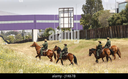 San Ysidro, CA, USA. 21st Apr, 2017. The San Diego Sector Customs and Border Protection horse patrol rode along the border with Mexico before a press conference featuring attorney general Jeff Sessions and Homeland Security Secretary John Kelly. At rigth in brown is the old border fence. In purple at top of photo is the Cross Border Xpress, a pathway for those in the United States to cross over, take and return from flights in Mexico at Tijuana's Rodriguez airport. Credit: John Gastaldo/ZUMA Wire/Alamy Live News Stock Photo