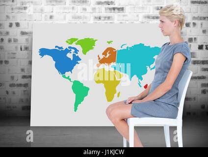 Digital composite of Woman sitting on chair next to Colorful Map with brick wall background Stock Photo