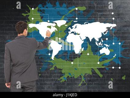 Digital composite of Businessman drawing  on Colorful Map with paint splatters on wall background Stock Photo