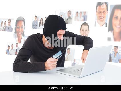 Digital composite of Criminal in hood on laptop with card in front of peoples profile faces Stock Photo
