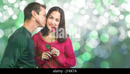 Digital composite of Portrait of woman holding rose while man kissing her over bokeh background Stock Photo