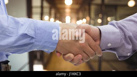 Digital composite of Close-up of handshake in office Stock Photo