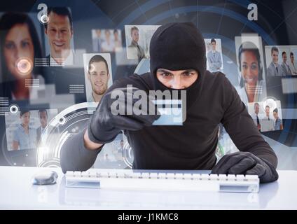 Digital composite of Criminal in hood on laptop with card in front of peoples profile faces Stock Photo