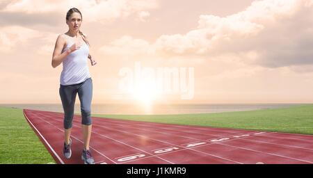 Digital composite of Digital composite image of female running on tracks Stock Photo