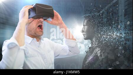 Digital composite of 3D black male AI and man in VR with mouth open against servers and flares Stock Photo