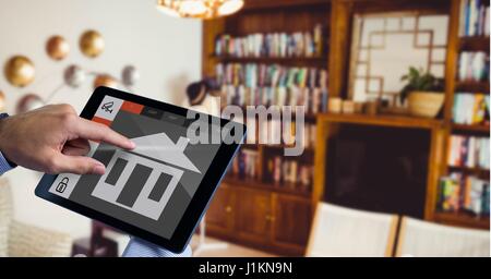 Digital composite of Hand using smart home application on digital tablet Stock Photo
