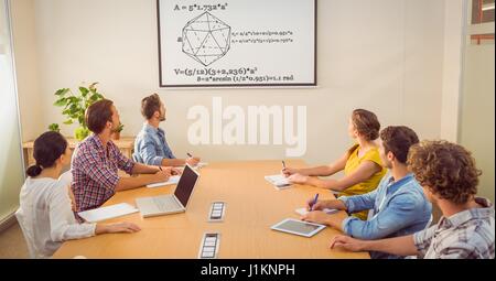Digital composite of Business people looking at diagram on screen in conference room Stock Photo