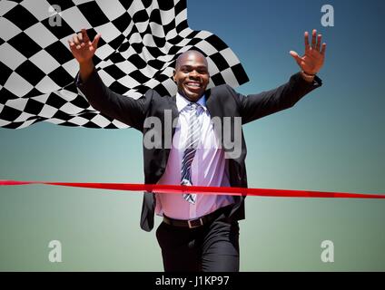 Digital composite of Business man reaching finish line against blue green background and checkered flag Stock Photo