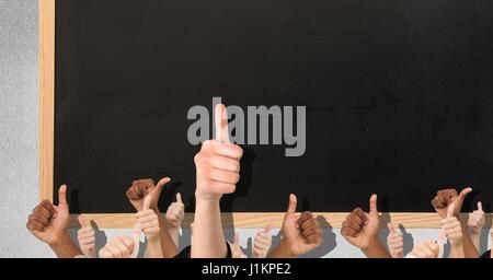 Digital composite of Thumbs up black blackboard Stock Photo