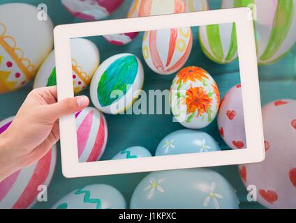 Digital composite of taking photo of Easter eggs with smart phone Stock Photo