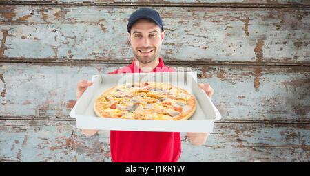 Digital composite of Delivery man showing pizza Stock Photo