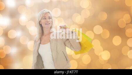 Digital composite of Woman holding shopping bags while looking away Stock Photo