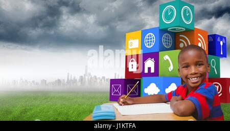 Digital composite of Happy boy writing at table with app icons in background Stock Photo