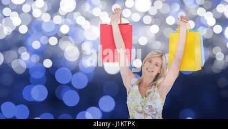 Digital composite of Happy woman with arms raised holding shopping bags Stock Photo