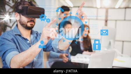 Digital composite of Digitally generated image of businessman touching icons while using VR glasses with colleagues in ba Stock Photo