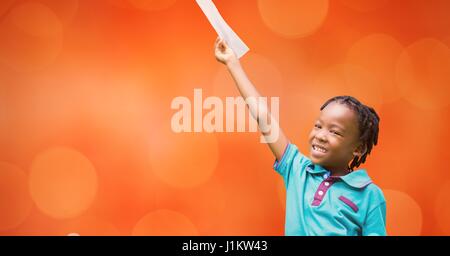 Digital composite of Happy girl holding document against orange background Stock Photo