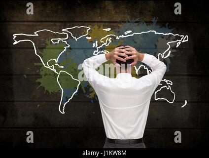 Digital composite of Businessman holding head looking at Colorful Map with paint splatters on wall background Stock Photo